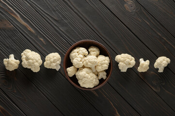 Raw, fresh organic cauliflower on a wooden background. Healthy eating, low carb diet concept