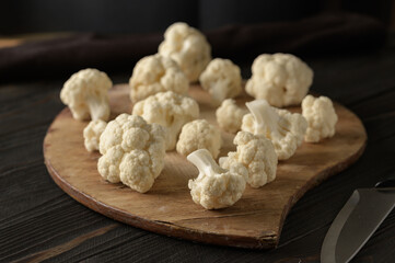 Raw, fresh organic cauliflower on a wooden background. Healthy eating, low carb diet concept