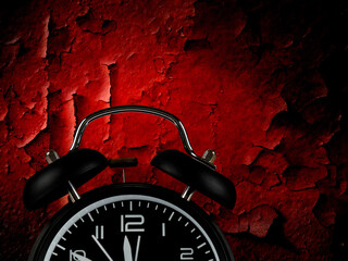 Alarm concept. Closeup of alarm clock nearing midnight, red background.