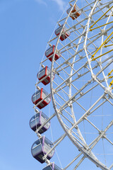 Big ferris with cabins wheel against deep blue sky. Part of of giant wheel in amusement park of Tbilisi, Georgia. Entertainment concept. 