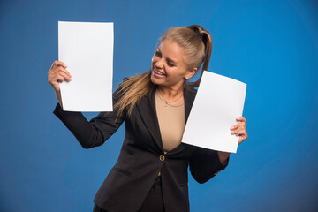 Female employee controlling documents and smiling