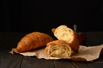 Fresh croissants on a wooden background.