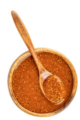 Top view of spoon and bowl with bavarian mustard on white background.