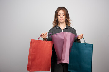Fototapeta na wymiar Photo of young woman holding shopping bags