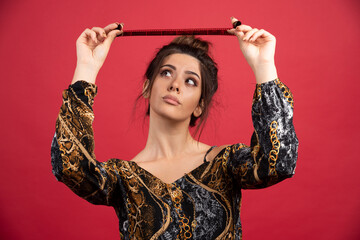 Brunette girl checks her photo history on polaroid film