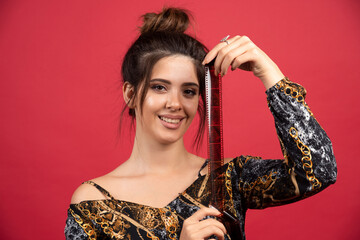 Brunette girl checks her photo history on polaroid film and looks satisfied