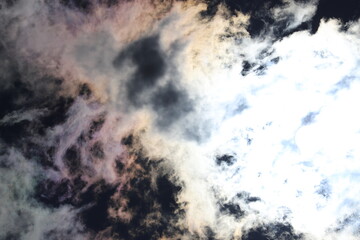 A beautiful background of clouds and the sun shining through them with the rays of a bright star.