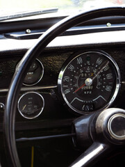 retro car dashboard interior. View of the steering wheel and dashboard of an old vintag car