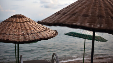 wicker umbrellas on a deserted sea beach