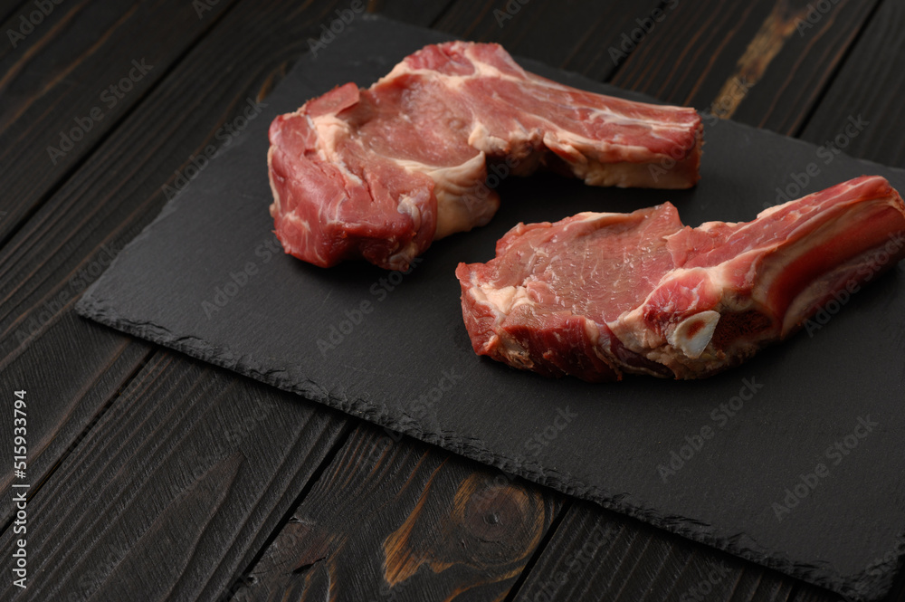 Wall mural raw fresh meat ribeye steak on rustic wooden background