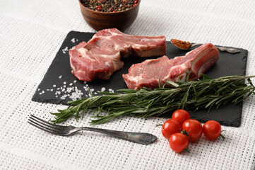 Raw cowboy steak and spices on a white background. BBQ Top view. Free space for text