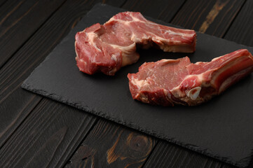 Raw fresh meat Ribeye Steak on rustic wooden background