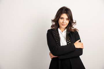 Positive woman in black jacket posing on white background