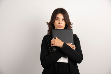 Portrait of female teacher with book on white background