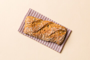Fresh loaves of bread with wheat and gluten on a colored table. bread on napkin on rustic background, fresh bread top view