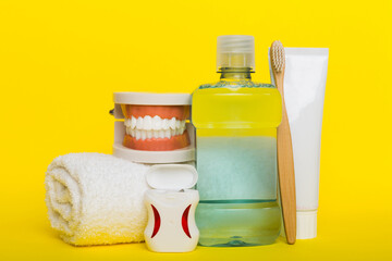 Mouthwash and other oral hygiene products on colored table top view with copy space. Flat lay. Dental hygiene. Oral care kit. Dentist concept