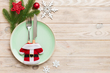 Christmas table place setting with christmas decor and plates, kine, fork and spoon. Christmas holiday background. Top view with copy space