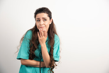 Portrait of female healthcare worker posing on white background