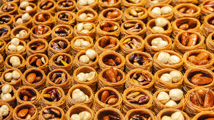 Kataifi Kadayif Kunafa Baklava Pastry Nests. Close up view of delicious pastry nest cookies dessert with nuts and honey. Food background. Turkish or Middle eastern dessert concept