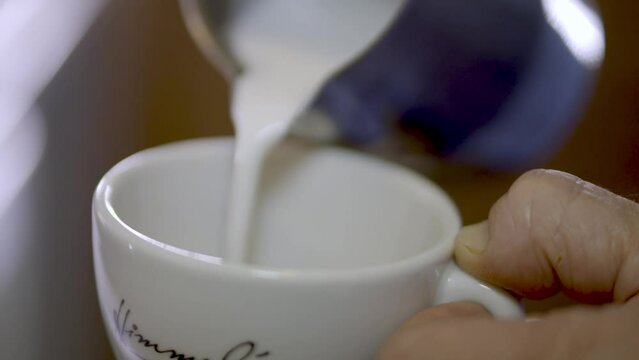 Cream Pouring Into Coffee