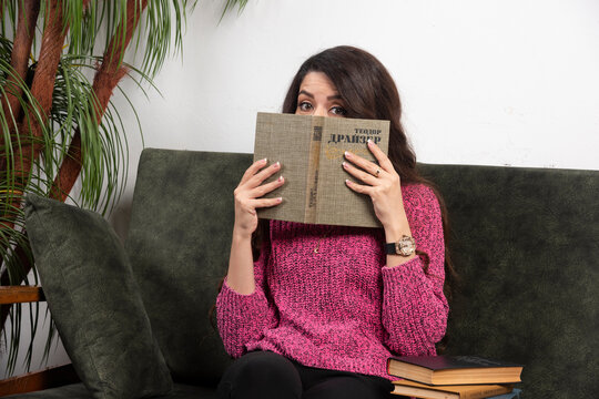 Brunette Woman Hiding Behind Of Book