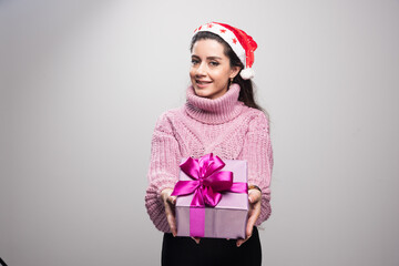 Young beautiful girl holding her gift to the camera