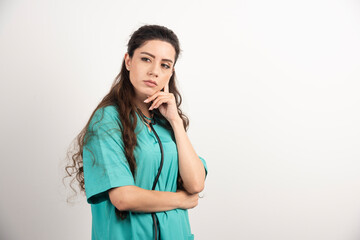Portrait of female healthcare worker posing on white background