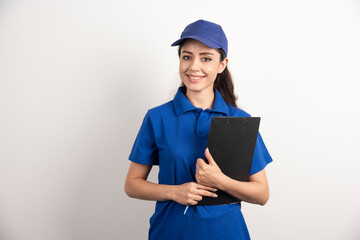 A portrait of a delivery young woman with clipboard