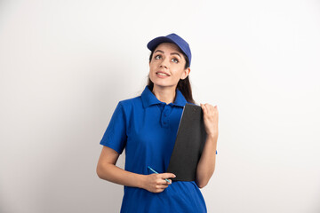 Young female courier in blue scrubs holding a clipboard