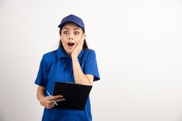 Shocked professional delivery woman on white background
