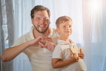 Fototapeta premium fathers day, Happy family adult parent dad and small son having fun at home