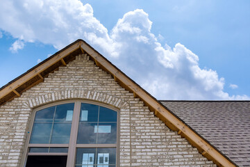 Roofing construction on a part of the new house covered in asphalt shingles