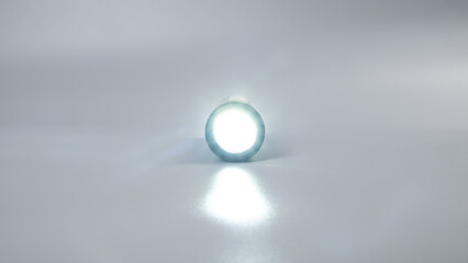 led flashlight on gray background, travel light source.