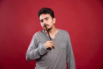 Artist putting his brush up to his head and thinking about creative ideas