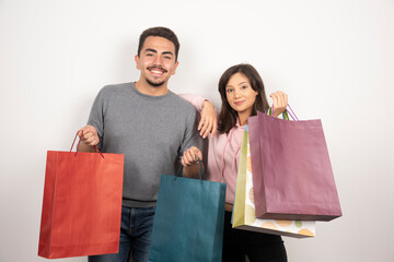 Happy couple holding shopping bags together