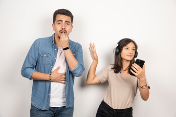 Man having breakdown while woman dancing around music