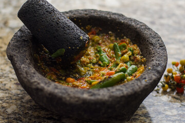Mexican spicy sauce in a traditional molcajete