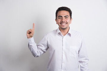 Young businessman pointing upside on white background