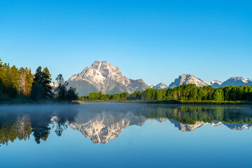 Fototapeta na wymiar landscape of snow mountain reflecting in the lake in the morning