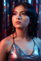 portrait of a teenage girl on a prom dance floor, party make-up, silver rainbow background © Sebastian Varlo