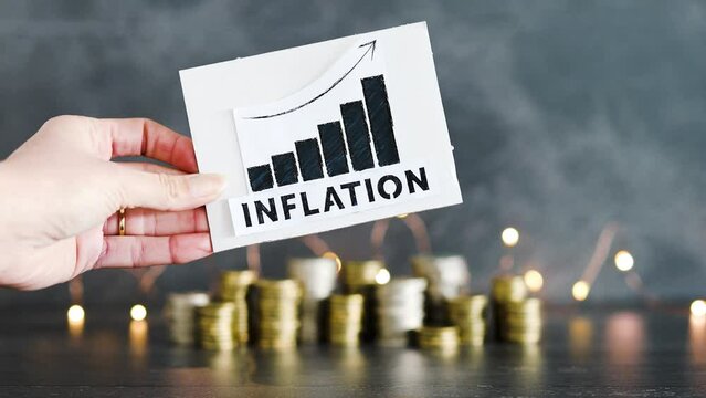 consumer prices increase and inflation going up, graph with stats and text in front of stacks of coins with fairy lights