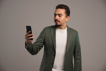 A businessman in dress code checking his phone