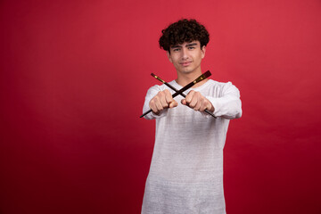 Male artist posing with painting brushes