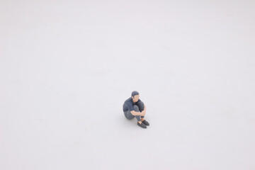a mini figure of homeless male begging