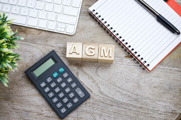 Annual general meeting concept with AGM wordings on the wooden blocks