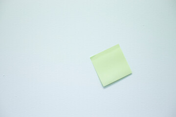 An empty post-it note sticks on the wall