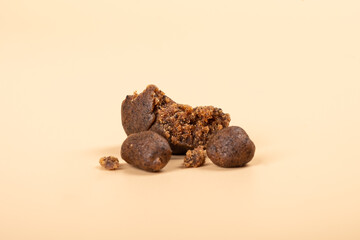 high thc extract, crumbled cannabis hashish slices on beige background.