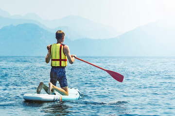 Sap surfing. Teenager rakes a wave with a paddle, the concept of an active lifestyle