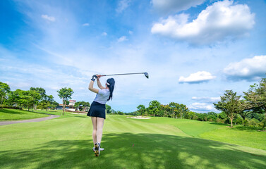 Professional woman golfer teeing golf in golf tournament competition at golf course for winner