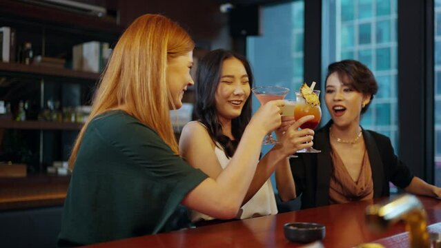 4K Group of Attractive woman enjoy and fun hangout nightlife meeting and drinking fancy cocktail together at luxury bar. Happy female friends celebrating holiday event party at nightclub in the city